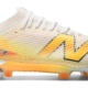 New Balance Furon v9 Elite FG blanc cassé avec dégradé orange et jaune, vue de profil
